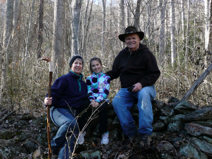 Yours truly with my wife and our granddaughter perched atop an old rock wall at the home place where my father spent the most memorable days of his youth.