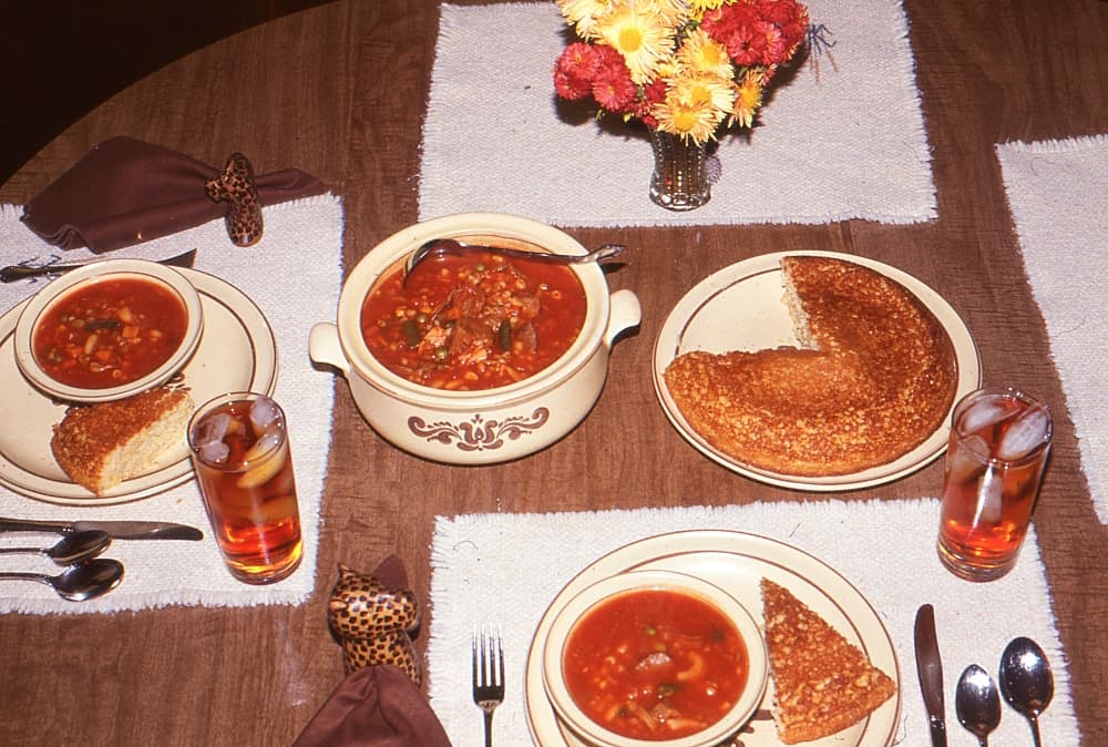 table set with cornbread and soup